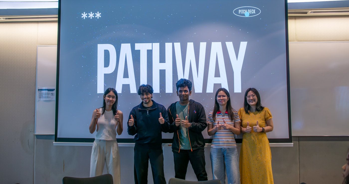 A team celebrating on the Pathway stage after presenting their working AI agent at APEX Bootcamp: RealRelay Edition