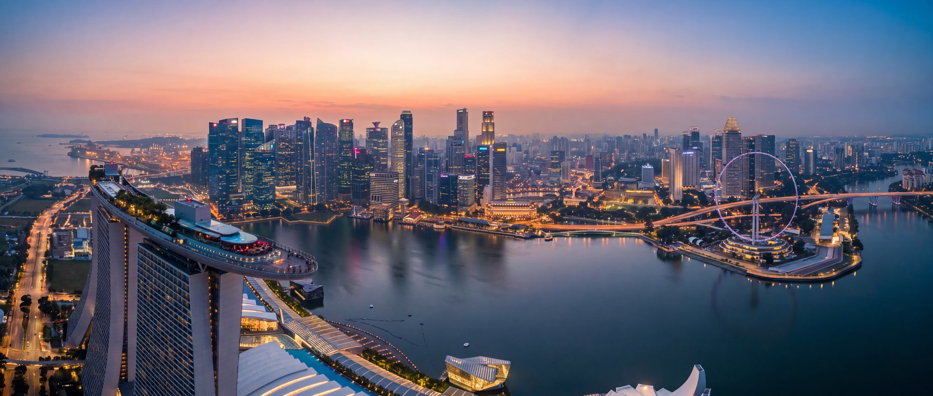 Aerial view of the Singapore Marina Bay skyline and central business district at dusk